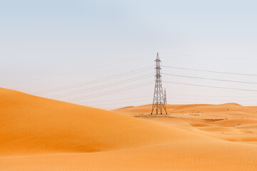 Electric power transmission lines, power line in the field in Liwa region, United Arab Emirates