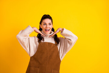 Poster - Portrait of attractive cheerful dreamy girl posing having fun enjoying good mood isolated over bright yellow color background