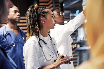 Wall Mural - Young doctors brainstorming together using sticky notes