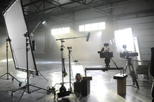 Profesional Video Studio.Behind-the-scenes Of A Video Shooting.Behind The Shooting Production Silhouette Of Camera And Equipment In Studio.Selective Focus.