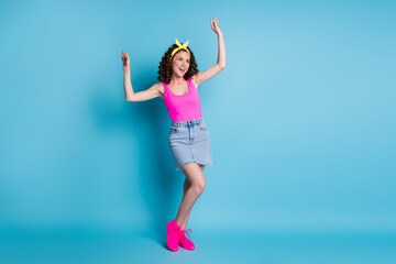 Poster - Full body photo of happy young charming woman raise hands look empty space isolated on blue color background