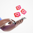 Cartoon character african american hands holding smartphone with like heart notifications over white background. Social network concept.