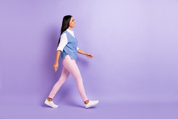 Wall Mural - Full length body size profile side view of attractive cheerful woman office worker walking isolated over violet purple color background