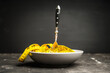 Yellow measuring tape in bowl like spaghetti with fork. Concept of diet. Selective focus. 