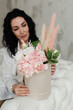 © Natalia - brunette girl with curly hair with a bouquet of flowers