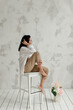 © Natalia - bare feet of a brunette girl sitting on a high white chair
