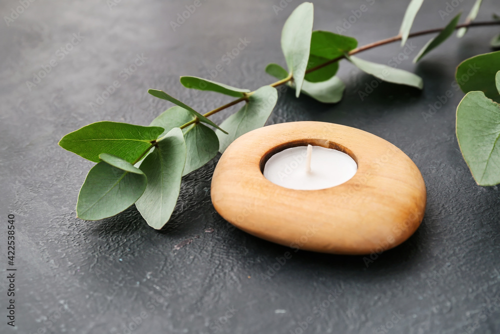 Stylish candle in holder on dark background