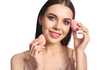 Wall Mural - Beautiful young woman with makeup sponges on white background