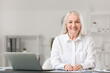 © Pixel-Shot - Portrait of happy mature woman in office