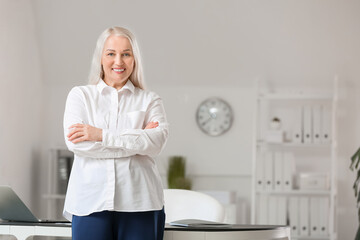 Canvas Print - Portrait of happy mature woman in office