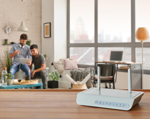 Wall Mural - Modem and router box on the table and living room background blur concept.