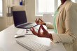 © Studio Romantic - Office worker relieving stress during work day. Calm young black woman sitting at desk with laptop computer, doing Gyan Mudra, meditating, relaxing and reaching zen, closeup. Body and mind health care