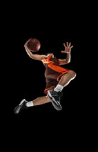 Young Professional Basketball Player In Action, Motion Isolated On Black Background, Look From The Bottom. Concept Of Sport, Movement, Energy And Dynamic.