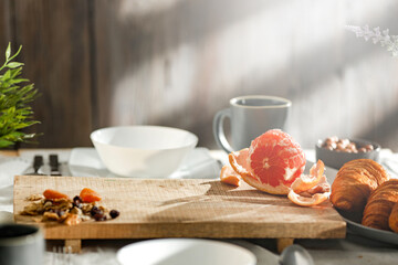 Wall Mural - Spring breakfast on a wooden table in a mountain hut in the morning 