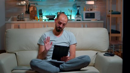 Poster - Focused man having online meeting videocall on tablet computer speaking using videoconference online web internet communication. Caucasian man browsing on internet for deadline project