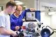 © industrieblick - Group of young people in technical vocational training with teacher