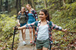 © BalanceFormCreative - Little girl hiking in nature with her mother and older sister.