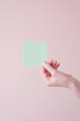 Hand holding blank sticky note. Memory and information concept with copy space