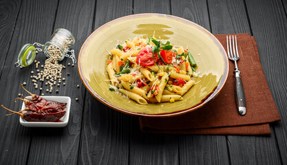 Wall Mural - Tomato and Bacon Penne Pasta on a wooden table