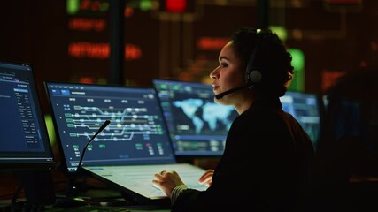 Aufkleber - Multiethnic Female IT Technical Support Specialist Talking with a Client in Headphones and Working on Desktop Computer in Monitoring Control Room with Big Digital Screens with Server Blockchain Data.