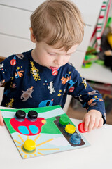 Wall Mural - Home made infant toddler game. bottle cups needs to screw in correct location. traffic light, car wheels and sun.