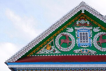 Detail of old traditional national rural wooden house with ornamental carved windows, frames in Purekh village (Nizhny Novgorod region, Russia). Russian folk style in architecture