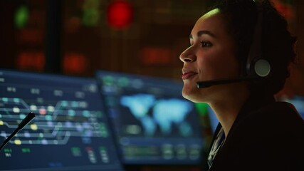 Poster - Close Up Portrait of Multiethnic Female IT Technical Support Specialist Talking with a Client in Headphones and Working on Desktop Computer in Monitoring Control Room with Big Digital Screens.