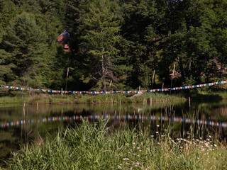 Sticker - lake in the woods with bhuddist prayer flags