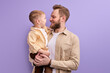 © alfa27 - adorable son boy and young father have fun, enjoying time together, isolated on purple
