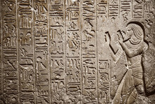 Egyptian Hieroglyphics On Limestone Wall In Egyptian Temple. Ancient Egyptian Hieroglyphs Carved On The Stone Wall
