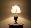 Coassic elegant lamp with illuminated lampshade on a small round table in the room