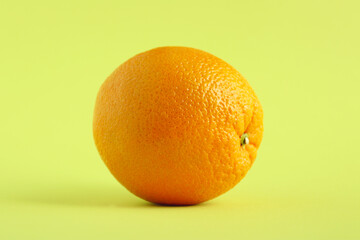 Fresh organic orange with a green background. Beautiful exotic fruit. Healthy fruit concept. Food background.