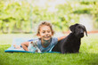 © oksix - Cute preschool girl play with pets on fresh grass