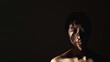 © golubovy - Female rights. Gender discrimination. Safety protection. Art portrait of insecure woman silhouette with abstract shadow pattern on face bare shoulders isolated on black night copy space background.