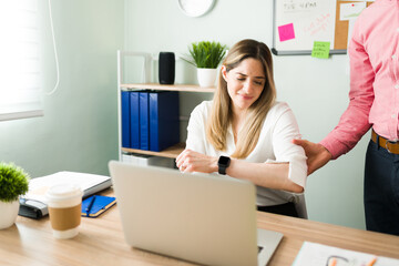 Male coworker touching the arm of a female colleague