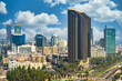 Aerial view of the city of San Deigo, CA downtown gaslamp district skyline filled with skyscrapers, hotels, business centers and road against a beautiful vivid cloud filled blue sky