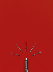 Set of bits and screwdriver on a red background, top view, copy space