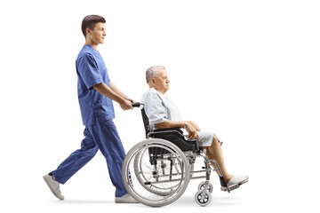 Wall Mural - Full length profile shot of a young male nurse pushing a patient in a wheelchair