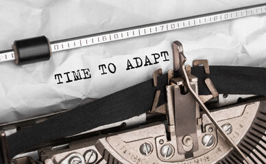 Poster - text time to adapt typed on retro typewriter