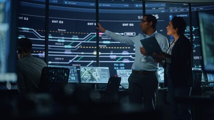 Aufkleber - In the System Control Room Project Manager and IT Technical Engineer with Laptop Have Discussion, surrounded by Multiple Monitors with Graphics. Big Monitor Shows Interactive Server Blockchain Info.