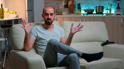 Poster - Pov of freelancer man sitting on couch recording business interview during coronavirus quarantine. Caucasian male speaking about lifestyle while looking at camera late at night in kitchen