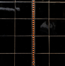 Black Tiles With A Orange Dotted Line Detail