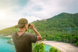 Man with binoculars inspects the beautiful nature around him, Koh Phangan, Thailand