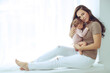 © nuzza11 - A young mother is holding her newborn baby. Mother of a nursing baby. Mother breastfeeding her baby. The family is at home. Portrait of a happy mother and child. High quality photo.