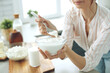 © nuzza11 - Young woman with milk at home in the kitchen. High quality photo.