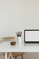 Wall Mural - Laptop computer with blank screen on table. Aesthetic minimal office workspace interior design template with mockup copy space.