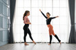 © godji10 - Female ballet teachers training ballerina to have right postures in the private class at home studio. Choreographer teaching caucasian dancers to movements of modern music. Concept of dance rehearsal