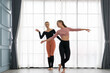 © godji10 - Female ballet teachers training ballerina to have right postures in the private class at home studio. Choreographer teaching caucasian dancers to movements of modern music. Concept of dance rehearsal