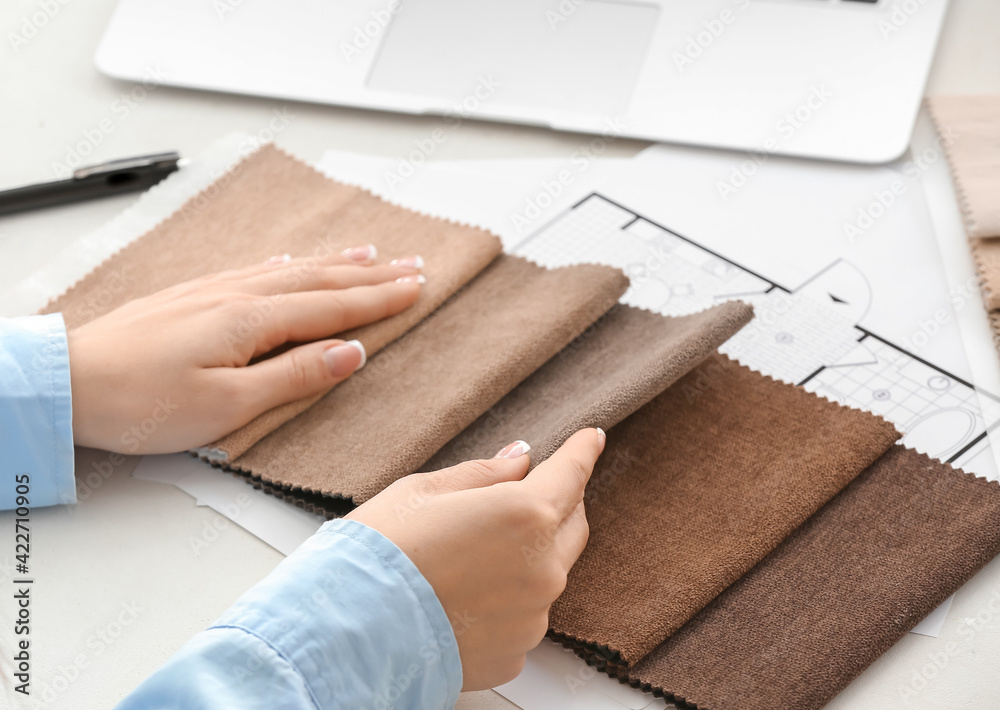 Female interior designer with fabric samples in office