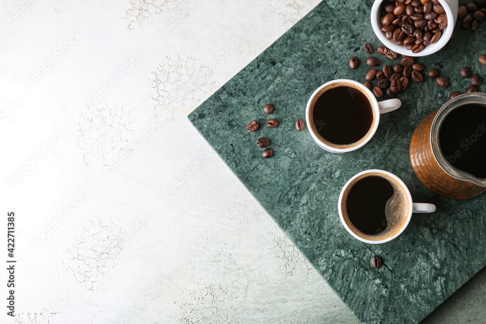 Cups of tasty hot coffee on grunge background